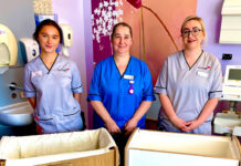 Midwife Amanda Wilson and students Lucy and Emma are pictured with both cots donated by Abilgail’s Footsteps.