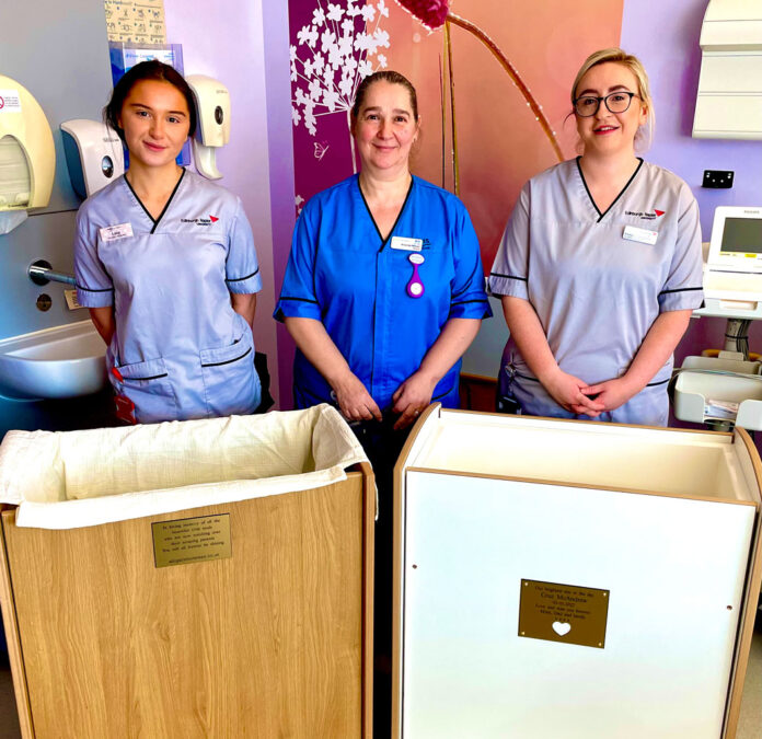 Midwife Amanda Wilson and students Lucy and Emma are pictured with both cots donated by Abilgail’s Footsteps.
