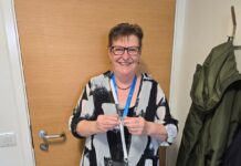 Dr Sharon Oswald holding award
