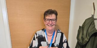 Dr Sharon Oswald holding award