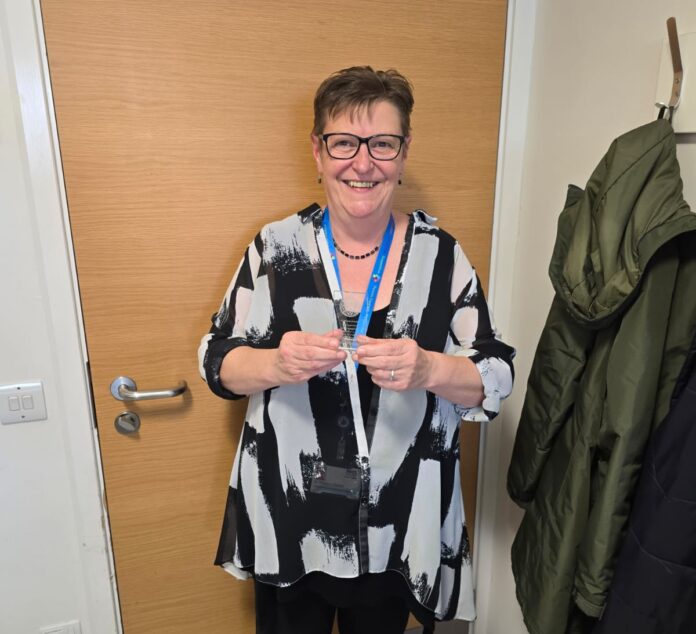 Dr Sharon Oswald holding award