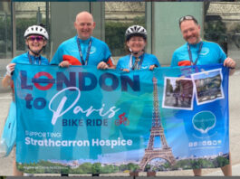 Friends raise £21,000 for Strathcarron Hospice in London to Paris Cycle Friends holding banner